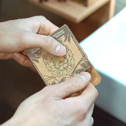 Hands lathering the Jungle Bravo alpha pheromone soap bar
